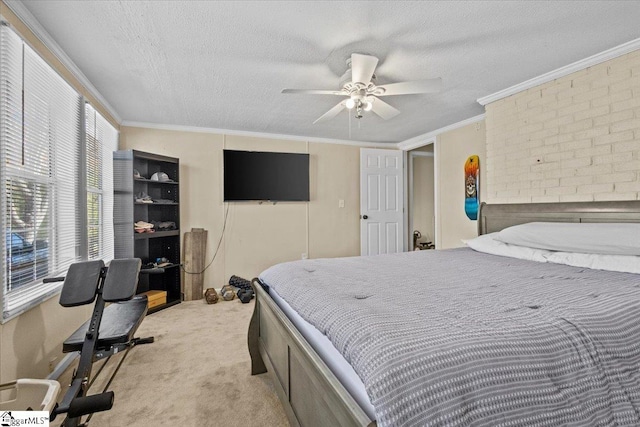 carpeted bedroom featuring ceiling fan, ornamental molding, and a textured ceiling