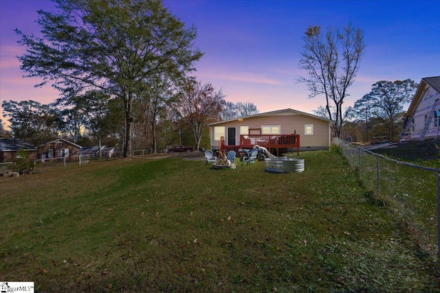 yard at dusk with a deck