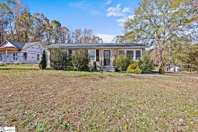 ranch-style home featuring a front yard