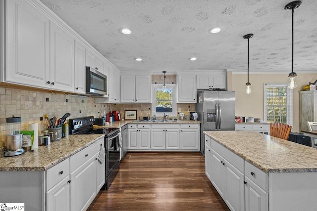 kitchen with white cabinetry, hanging light fixtures, stainless steel appliances, dark hardwood / wood-style flooring, and a textured ceiling