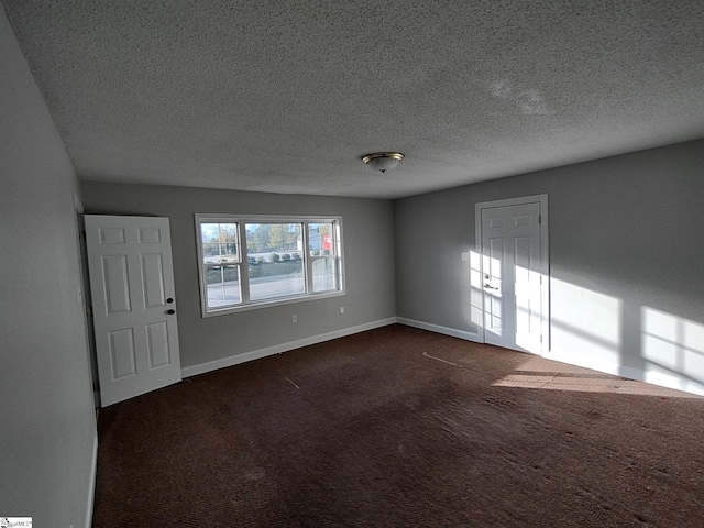 carpeted spare room featuring a textured ceiling