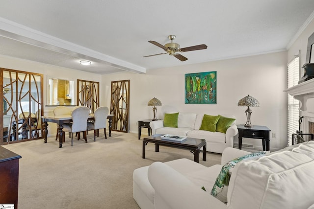 living room with carpet flooring, ceiling fan, and ornamental molding