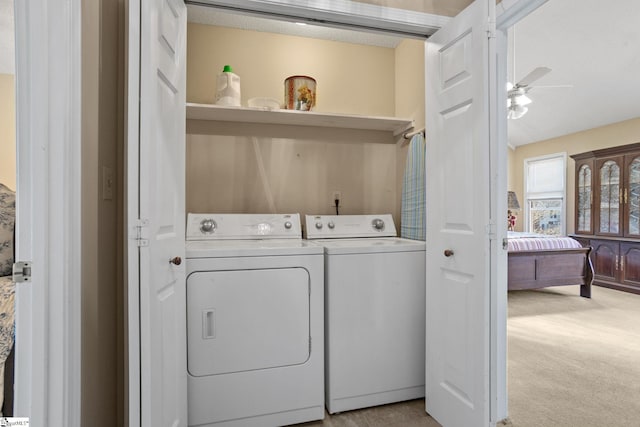 clothes washing area featuring ceiling fan, separate washer and dryer, and light carpet