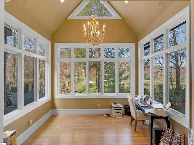 sunroom / solarium featuring a chandelier and lofted ceiling