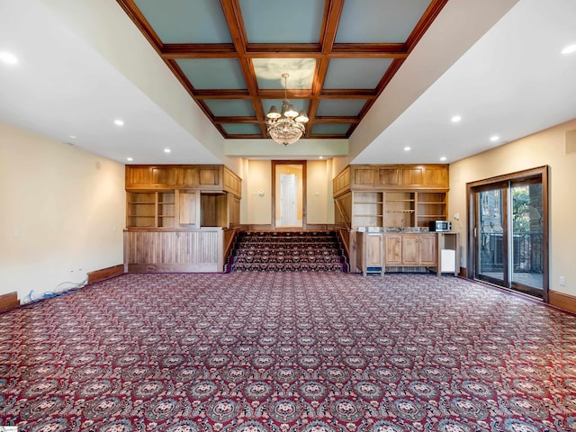 interior space with beam ceiling, built in shelves, coffered ceiling, a notable chandelier, and carpet