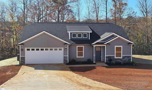 craftsman inspired home featuring a garage and central AC unit