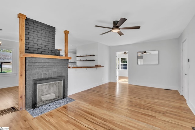 unfurnished living room featuring a fireplace and light hardwood / wood-style floors