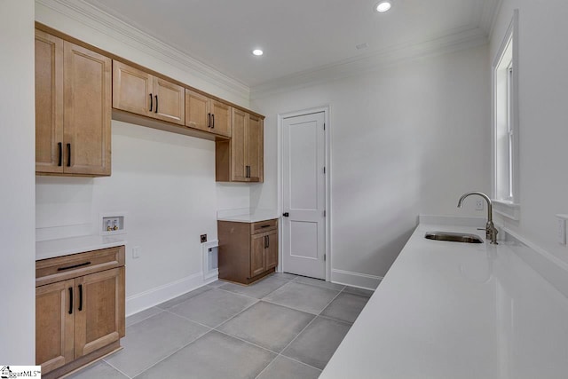 kitchen with crown molding, sink, and light tile patterned floors