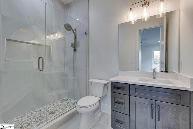 bathroom with tile patterned flooring, vanity, toilet, and a shower with door