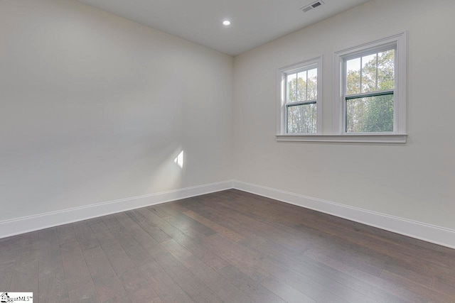 spare room featuring dark hardwood / wood-style flooring