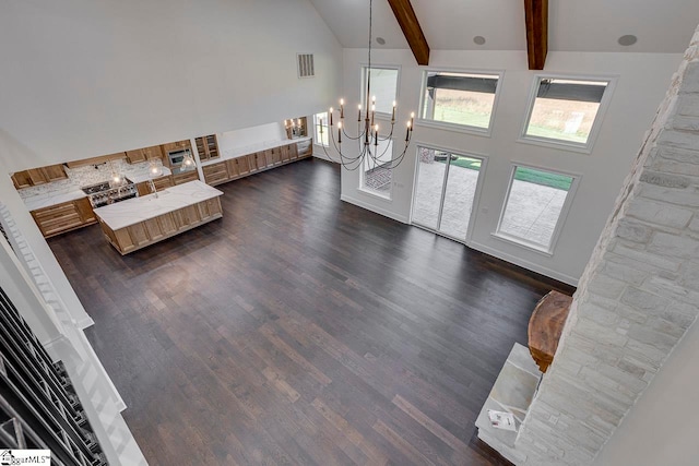 foyer entrance with beamed ceiling, dark hardwood / wood-style flooring, high vaulted ceiling, and a notable chandelier