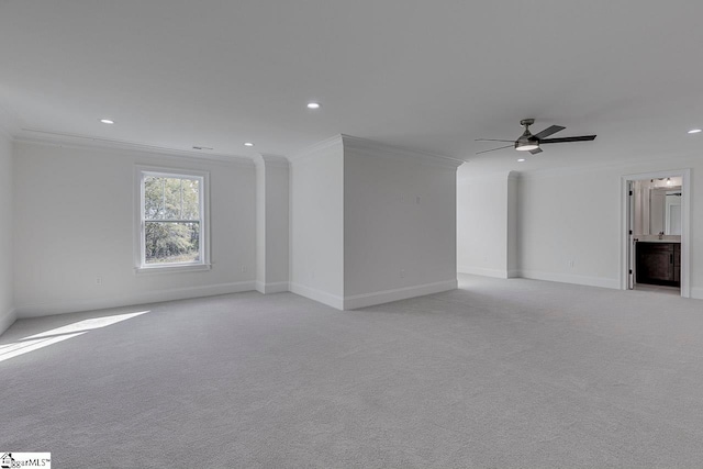 unfurnished living room with crown molding, ceiling fan, and light colored carpet