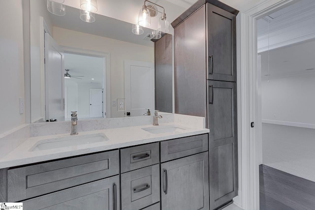 bathroom with ceiling fan and vanity