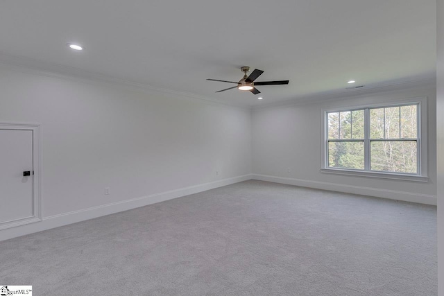 carpeted empty room featuring ceiling fan and ornamental molding