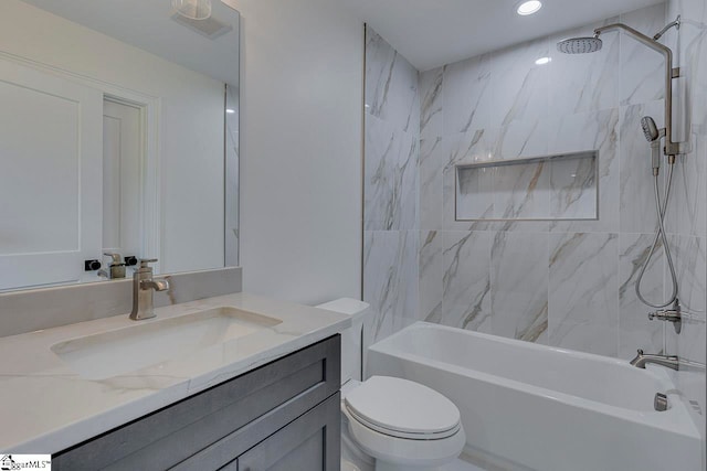 full bathroom with vanity, tiled shower / bath combo, and toilet