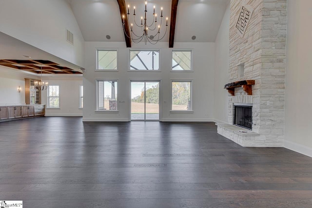 unfurnished living room with a stone fireplace, dark hardwood / wood-style flooring, and high vaulted ceiling