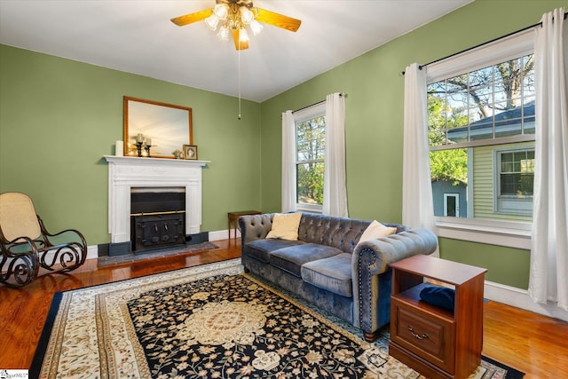 living room featuring light hardwood / wood-style floors, a wealth of natural light, and ceiling fan