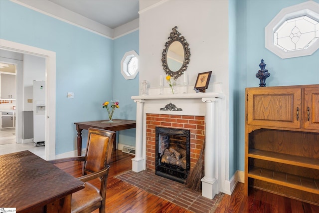 sitting room featuring a fireplace and hardwood / wood-style floors