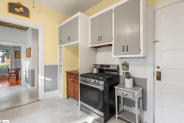 kitchen with gray cabinets and stainless steel range with gas cooktop