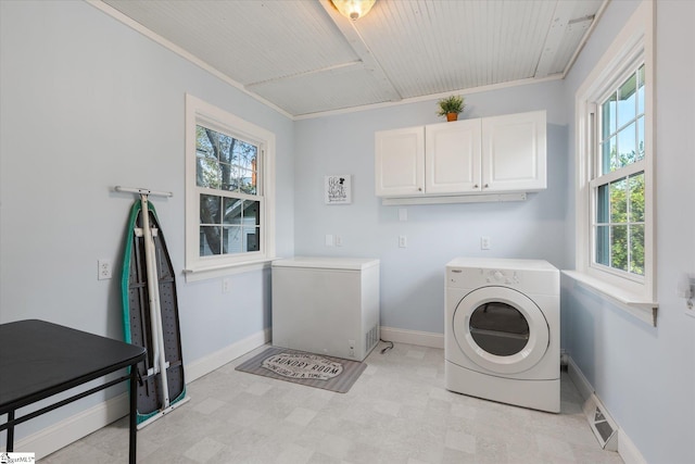 washroom featuring cabinets, separate washer and dryer, and ornamental molding