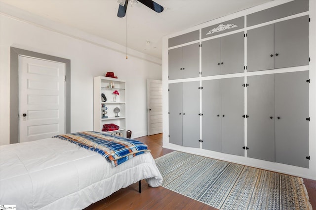 bedroom with ceiling fan and dark wood-type flooring