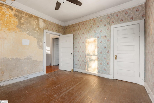 empty room with hardwood / wood-style flooring and ceiling fan