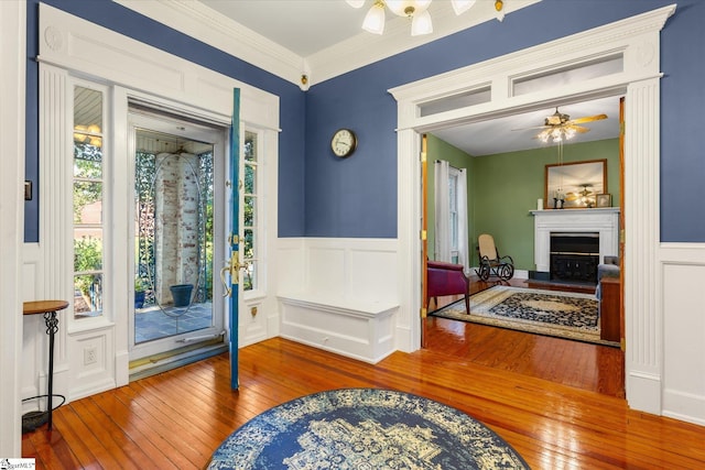 entryway featuring hardwood / wood-style flooring, ceiling fan, and crown molding