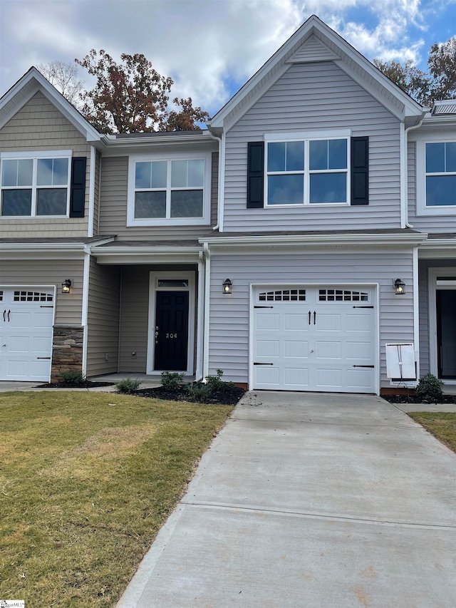 view of front of house with a garage and a front yard