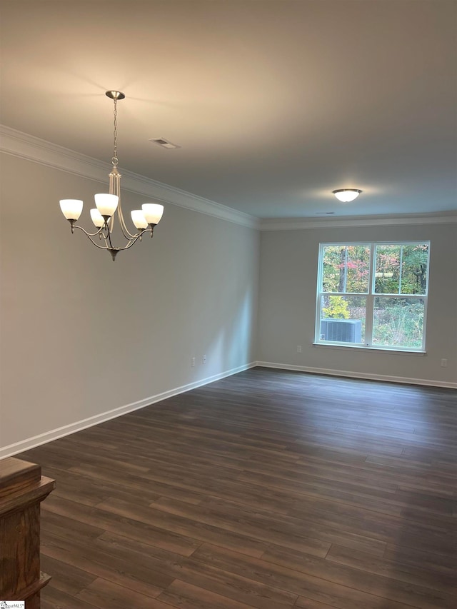 unfurnished room with a chandelier, ornamental molding, and dark wood-type flooring