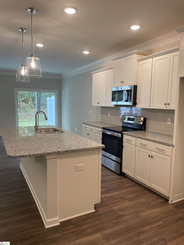 kitchen with white cabinetry, sink, stainless steel appliances, and a center island with sink