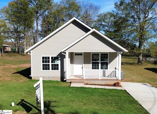 bungalow-style home featuring a porch and a front lawn