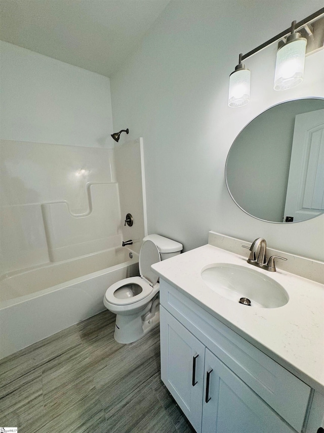 full bathroom featuring bathtub / shower combination, vanity, hardwood / wood-style flooring, and toilet