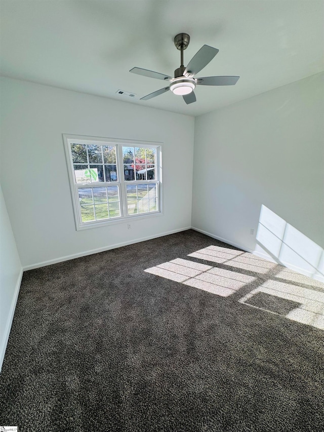 carpeted empty room featuring ceiling fan