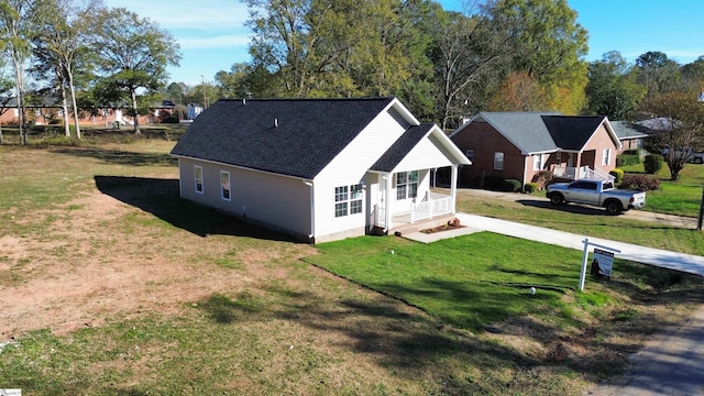 exterior space featuring a porch and a lawn