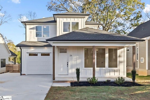 prairie-style house featuring a porch and a garage