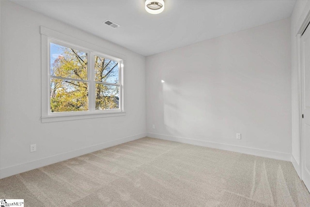 unfurnished room featuring light colored carpet