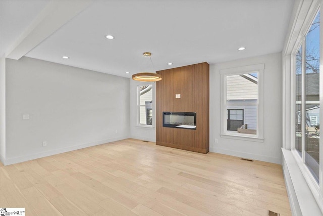 unfurnished living room with light wood-style floors, baseboards, and recessed lighting