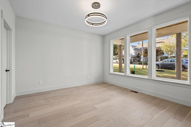 spare room with light hardwood / wood-style flooring