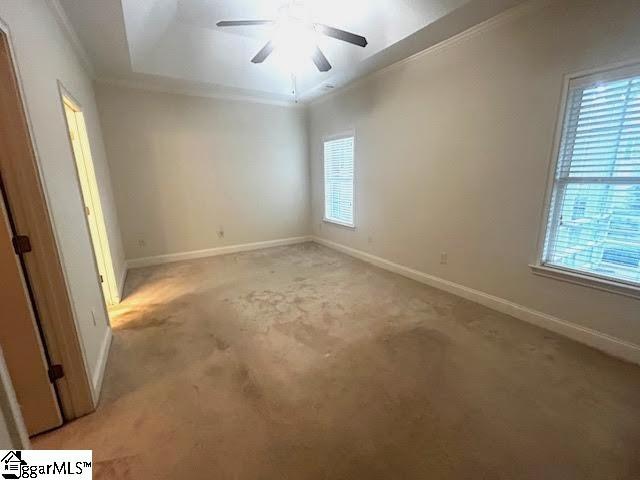 empty room with ornamental molding and baseboards