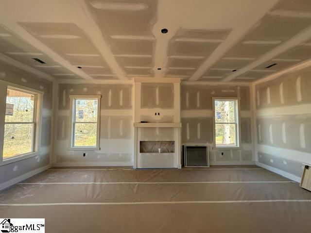 unfurnished living room featuring plenty of natural light