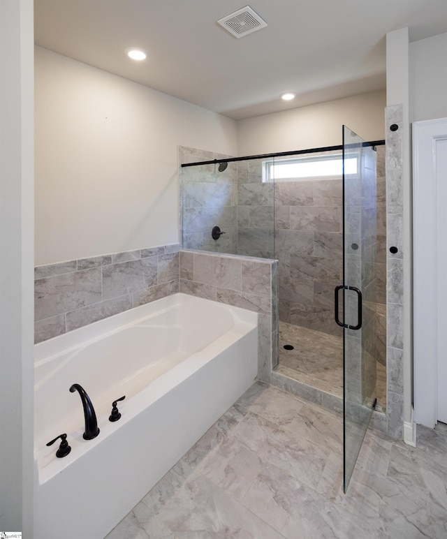 bathroom with shower with separate bathtub