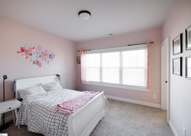 bedroom with light colored carpet