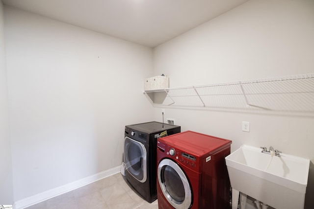 washroom with washing machine and dryer and sink