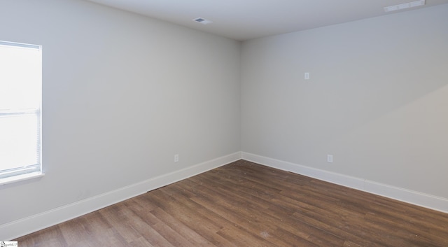 empty room with dark wood-type flooring