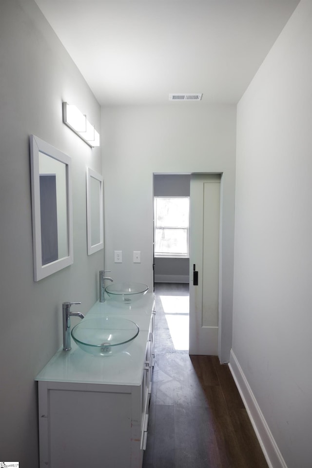 bathroom with hardwood / wood-style floors and vanity