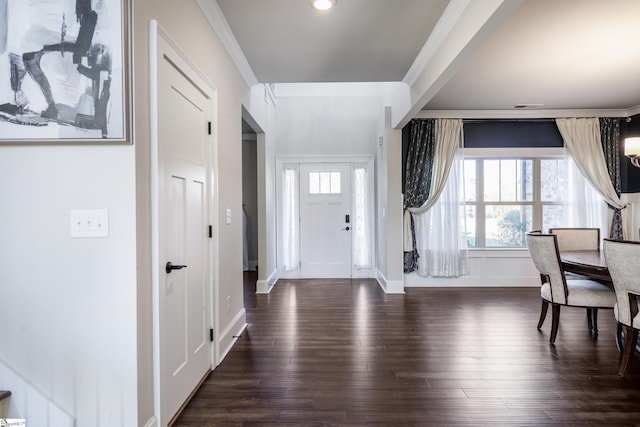 entrance foyer with dark hardwood / wood-style flooring and ornamental molding