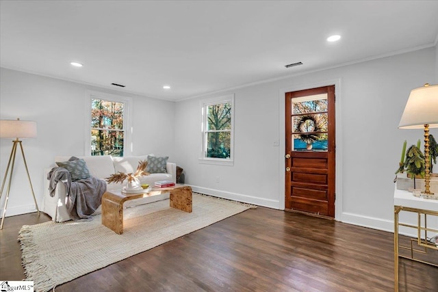 sitting room with dark hardwood / wood-style flooring and crown molding