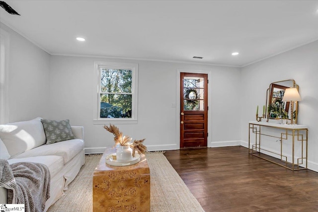 living room featuring dark hardwood / wood-style flooring and ornamental molding