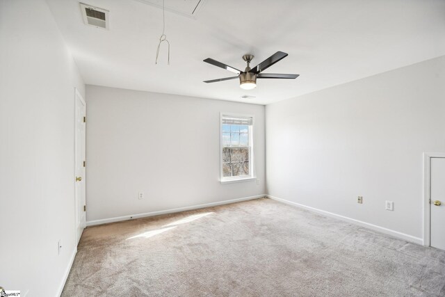 spare room with ceiling fan and light colored carpet