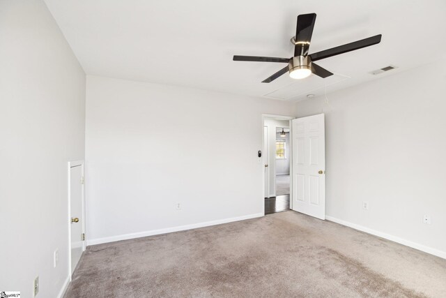 empty room with ceiling fan and carpet floors